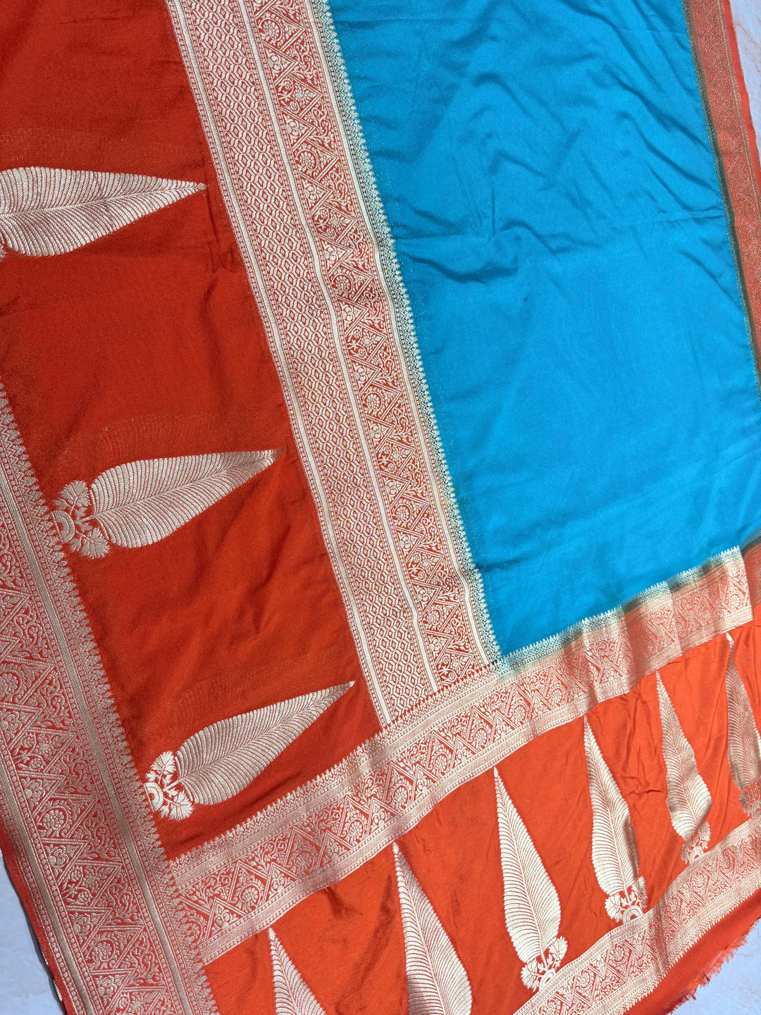 PEACOCK COLOUR KHADDI GEORGETTE WITH KAIRI BOOTA ON ORANGE BORDER