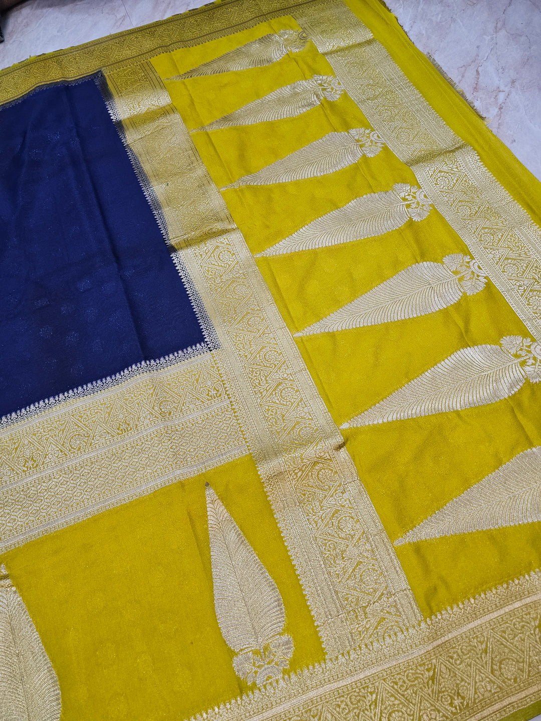 KHADDI GEORGETTE IN NAVY BLUE WITH GOLD BORDER