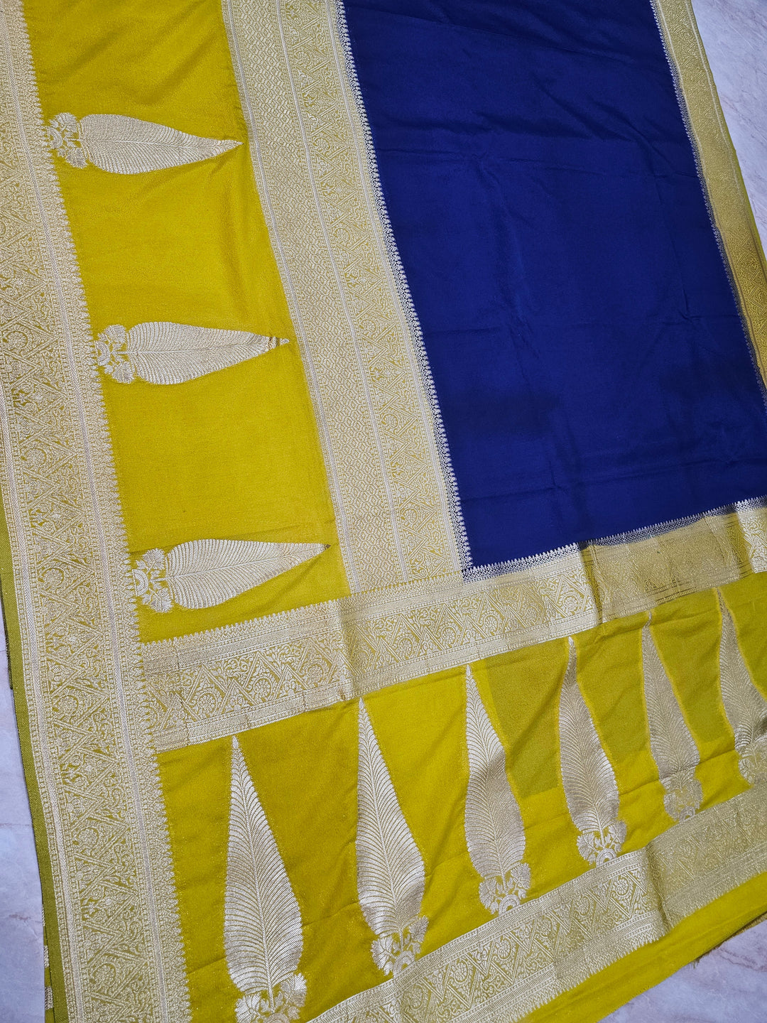 KHADDI GEORGETTE IN NAVY BLUE WITH GOLD BORDER
