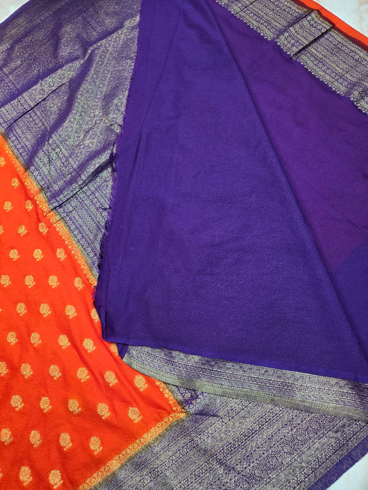 KHADDI GEORGETTE IN TANGY ORANGE WITH VIOLET BORDER