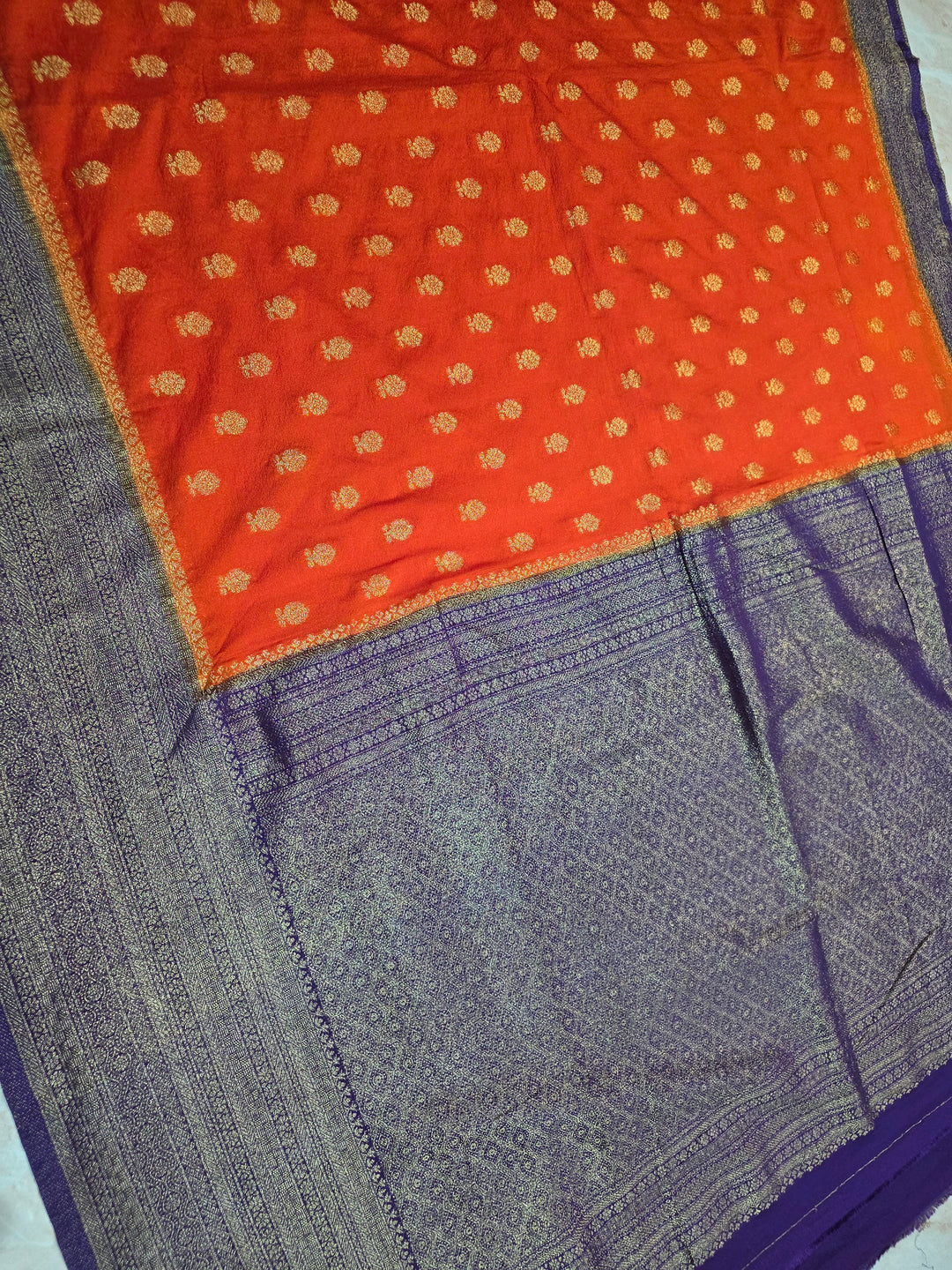 KHADDI GEORGETTE IN TANGY ORANGE WITH VIOLET BORDER