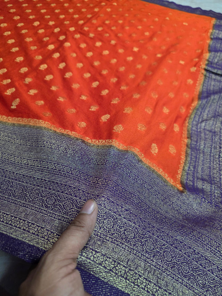 KHADDI GEORGETTE IN TANGY ORANGE WITH VIOLET BORDER