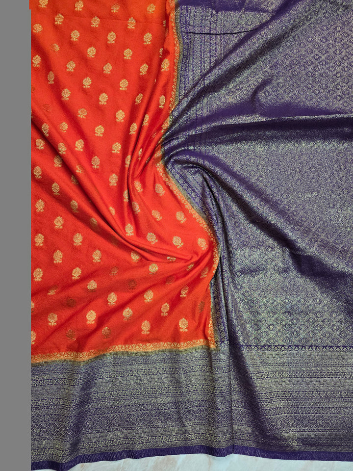 KHADDI GEORGETTE IN TANGY ORANGE WITH VIOLET BORDER