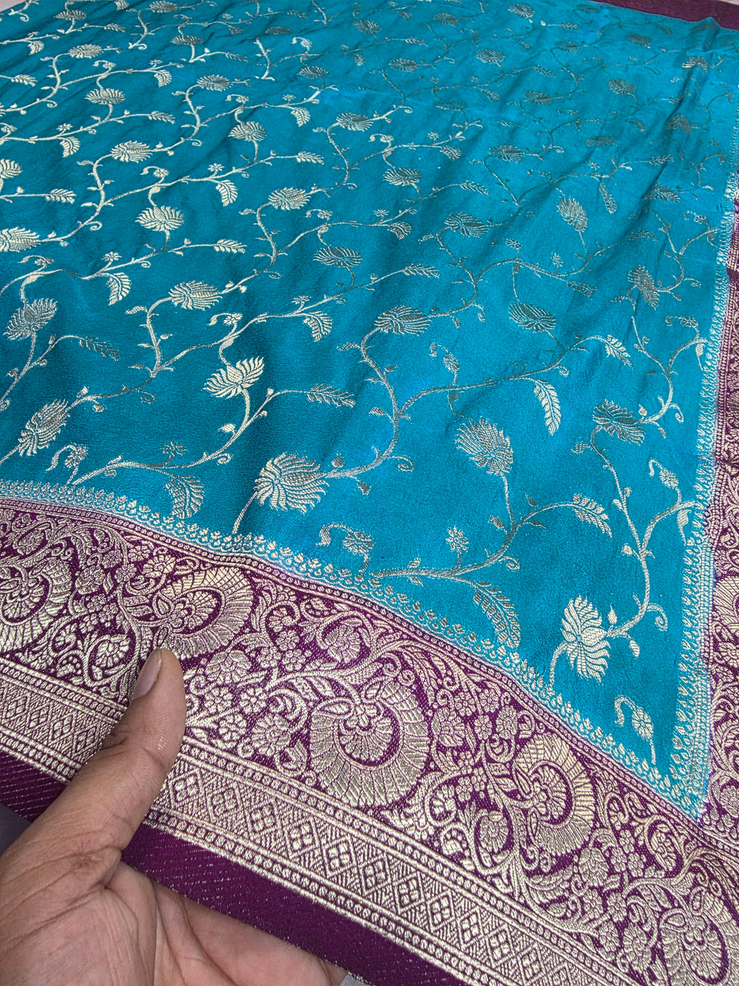 KHADDI GEORGETTE IN FEROZI BLUE WITH MAGENTA BORDER