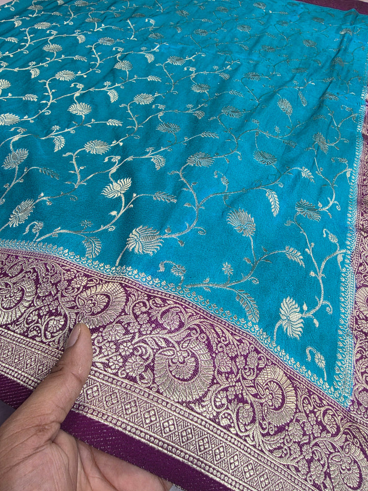 KHADDI GEORGETTE IN FEROZI BLUE WITH MAGENTA BORDER