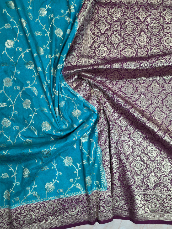 KHADDI GEORGETTE IN FEROZI BLUE WITH MAGENTA BORDER
