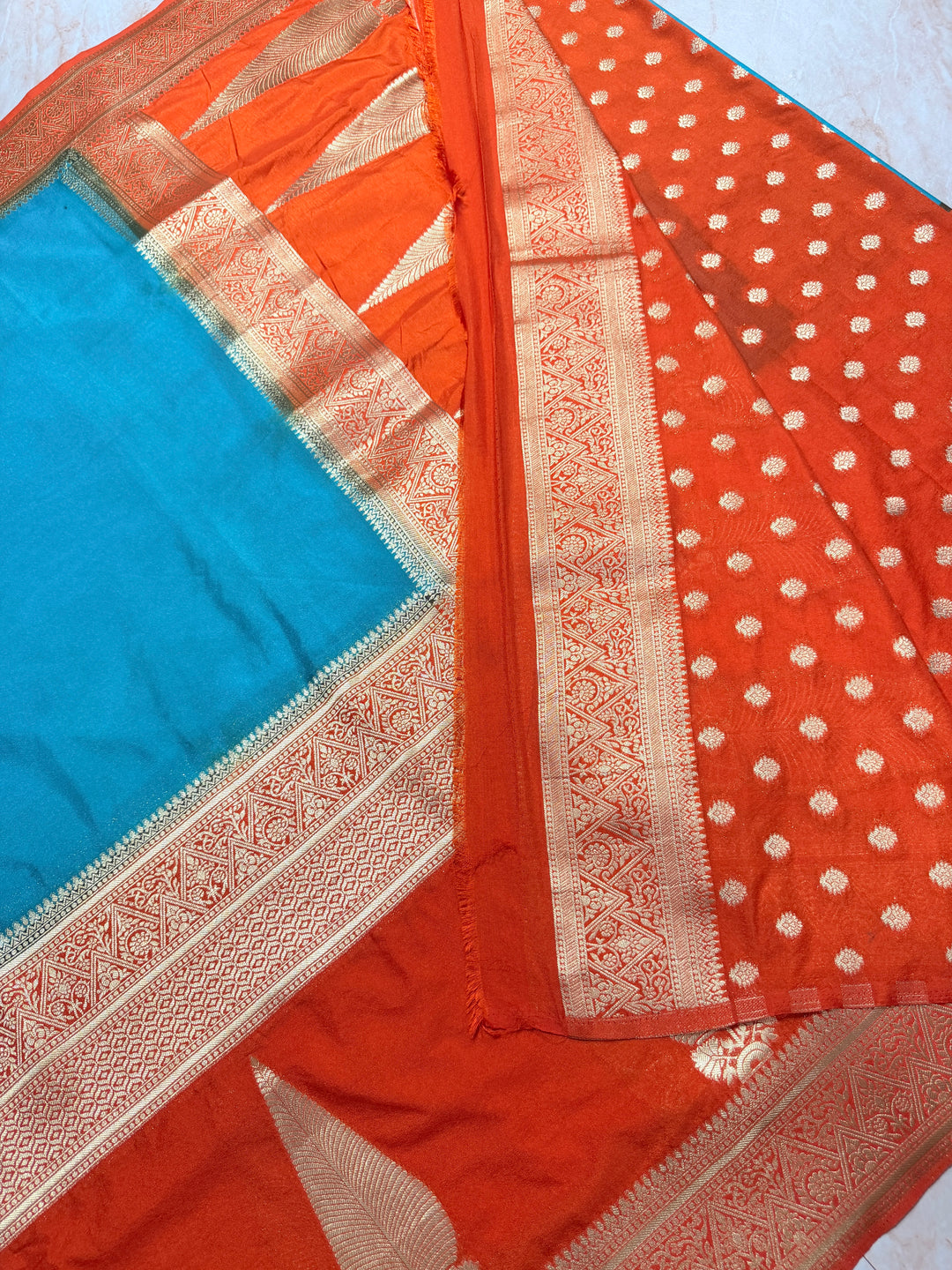 PEACOCK COLOUR KHADDI GEORGETTE WITH KAIRI BOOTA ON ORANGE BORDER