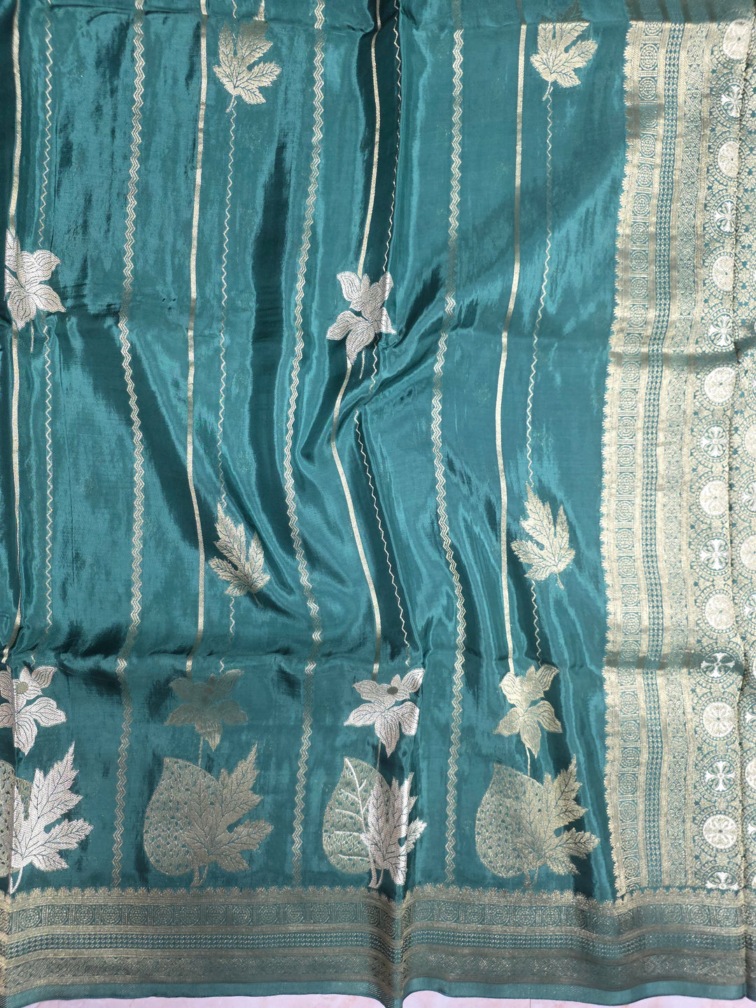 KOREAN SILK IN MATALLIC BOTTLE GREEN WITH GOLD AND SILVER ZARI WORK