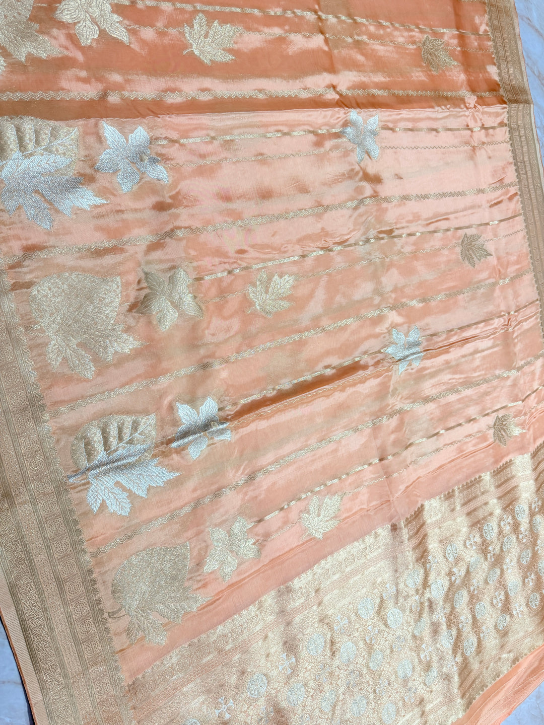 KOREAN SILK IN PEACH ORANGE WITH GOLD AND SILVER ZARI WORK