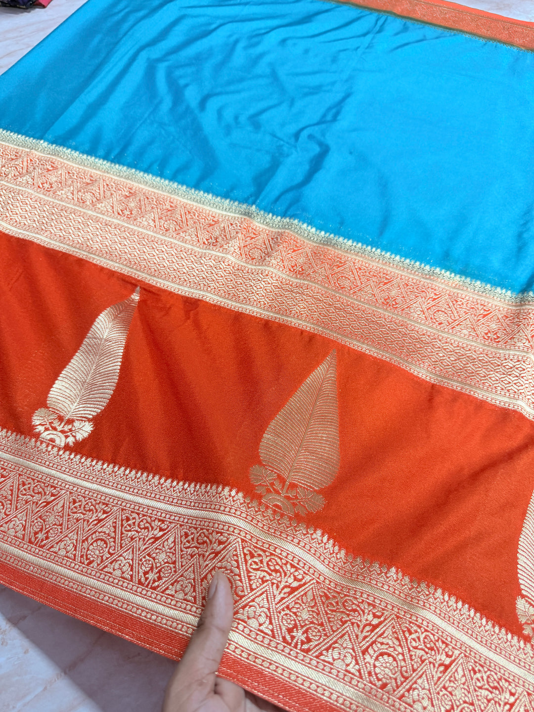 PEACOCK COLOUR KHADDI GEORGETTE WITH KAIRI BOOTA ON ORANGE BORDER