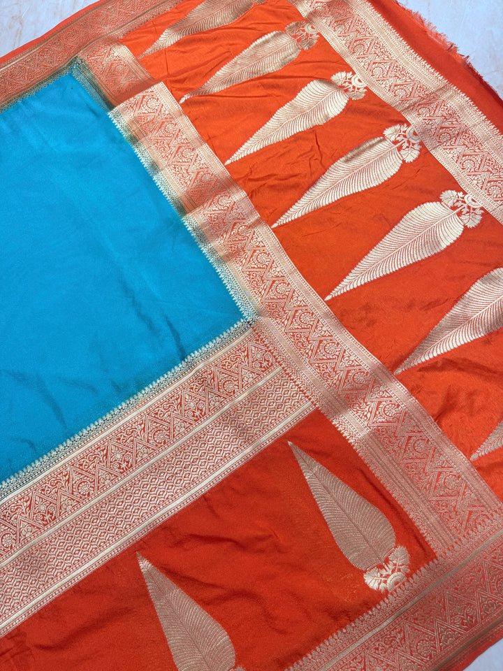 PEACOCK COLOUR KHADDI GEORGETTE WITH KAIRI BOOTA ON ORANGE BORDER