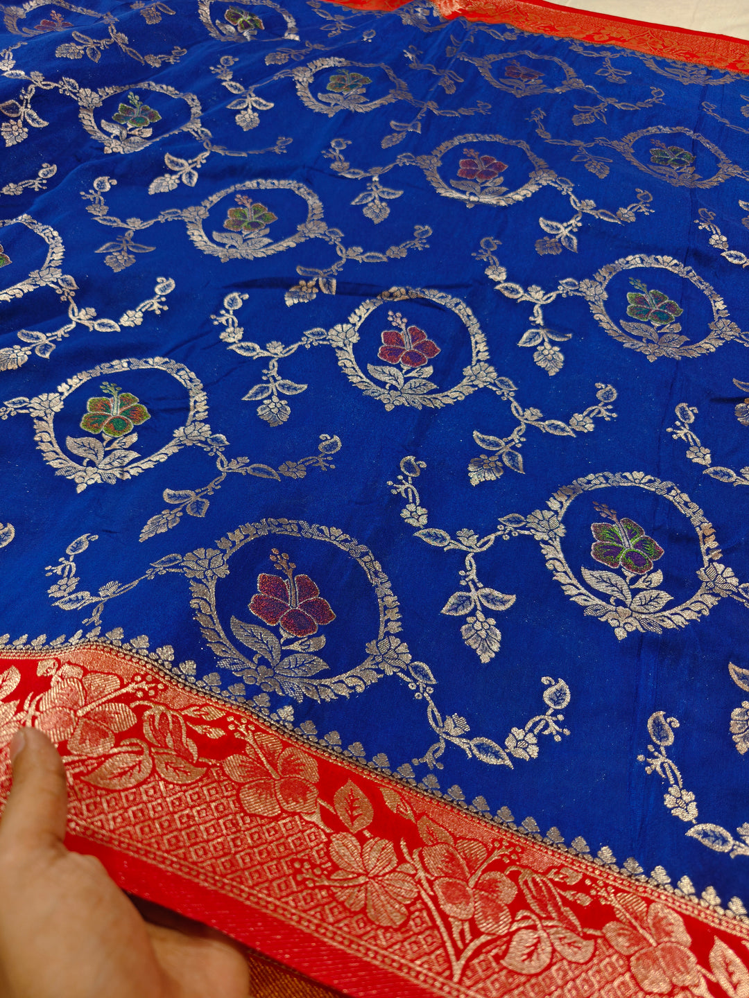 KHADDI GEORGETTE IN ROYAL BLUE WITH RED BORDER