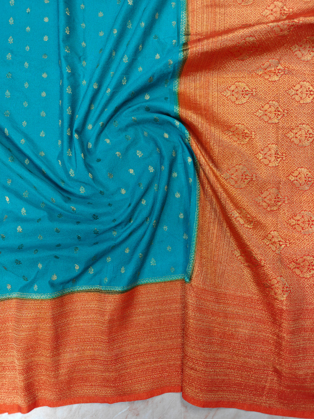 SEA GREEN KHADDI GEORGETTE WITH ORANGE BORDER