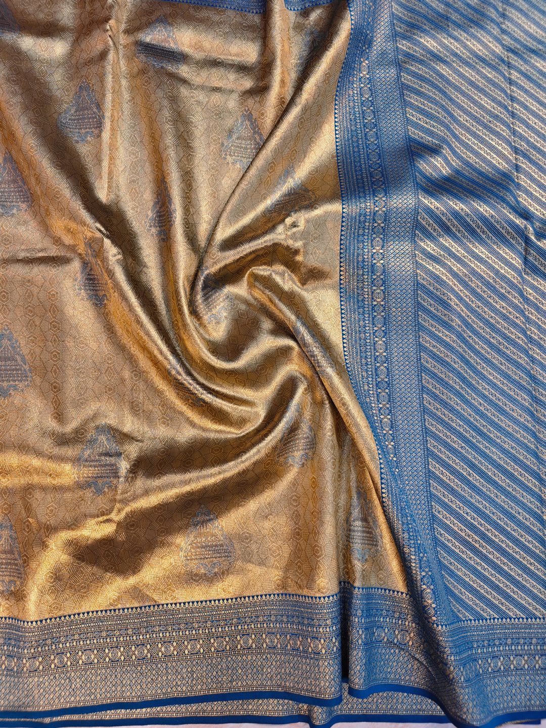 DHARMAVARAM ALFI IN GOLD WITH MEENA BOOTA AND BLUE BORDER