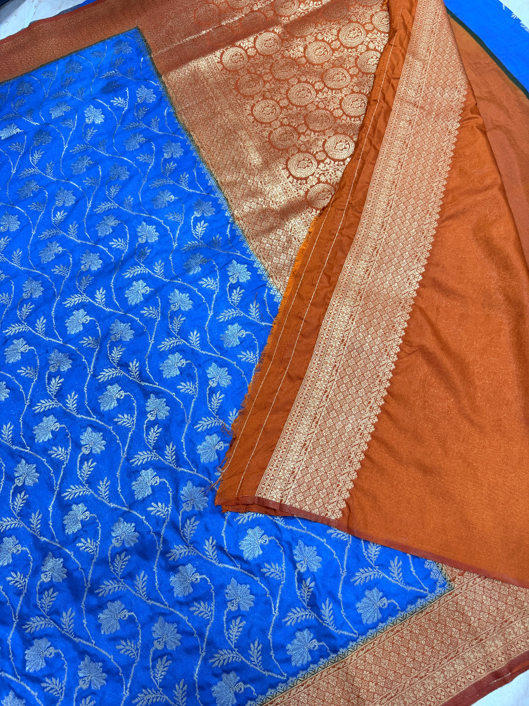 SEMI KHADDI GEORGETTE WITH ZARI MINA WEAVE IN ROYAL BLUE WITH COPPER RUST BORDER